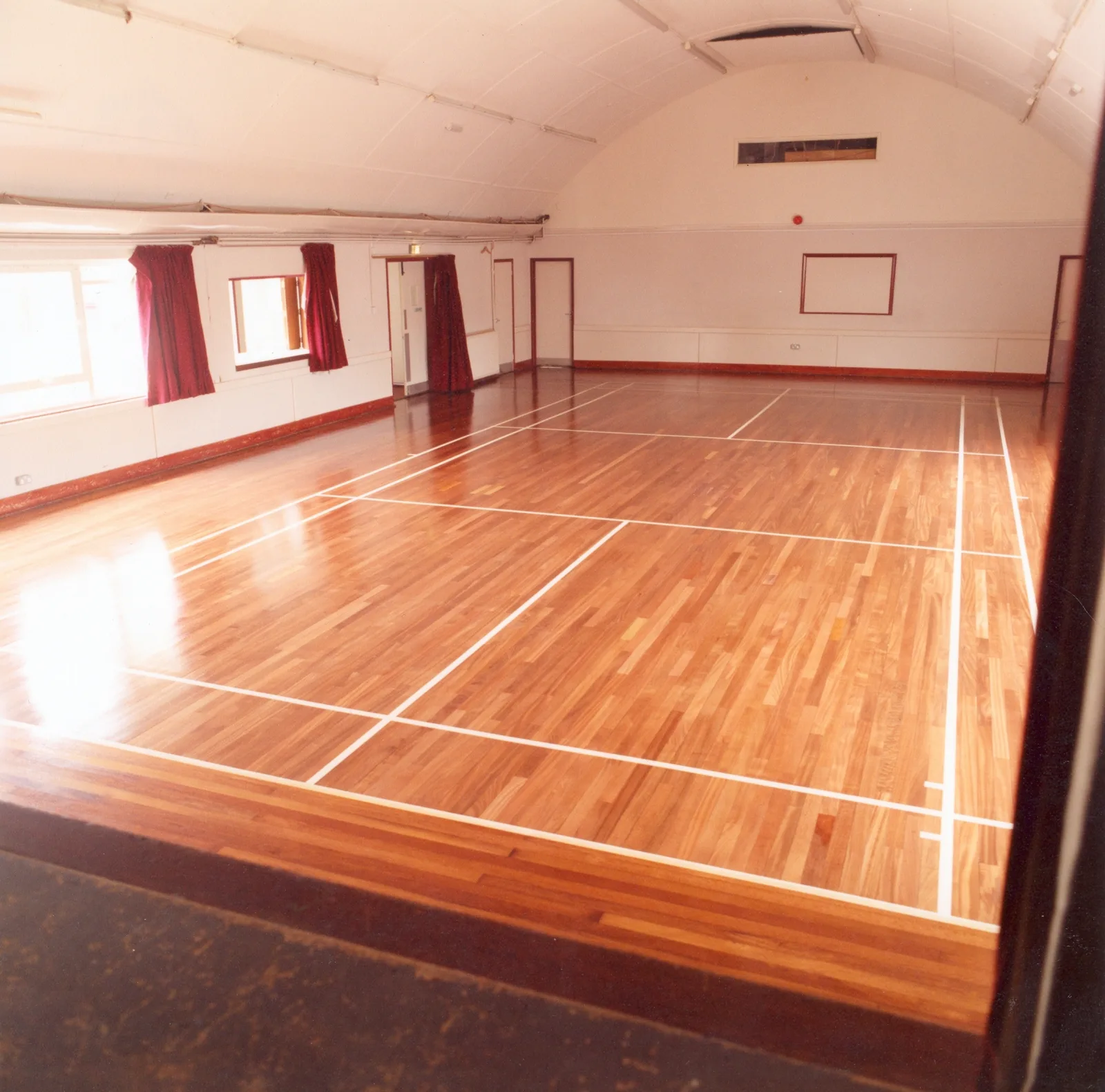 Restored and polished wooden sports hall floor